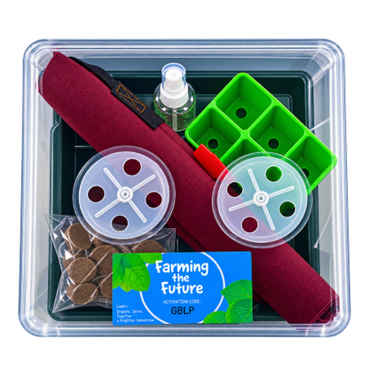 A comprehensive farm tool kit in a clear plastic storage container, featuring a dark green tray with a burgundy rolled fabric cover, a green plastic wheel, two clear plastic spool covers, a small spray bottle, a bag of brown organic material, and a blue 'Farming the Future' card.