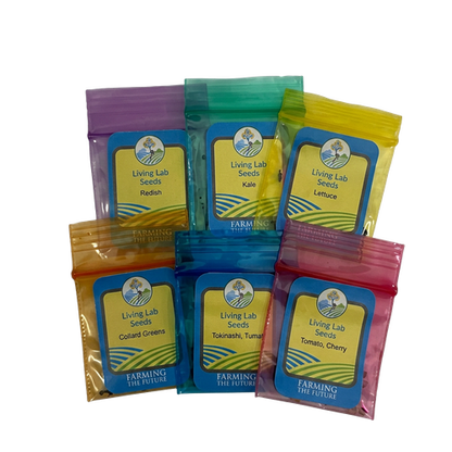 Seven resealable plastic seed packets in assorted colors arranged in a cluster on a white background. Each packet has a blue label with a tree logo and text including 'Living Lab Seeds' and 'Farming the Future.